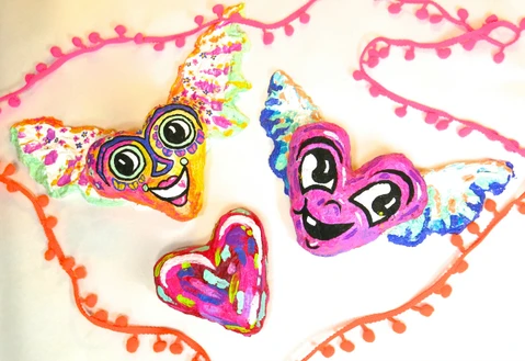 Paper mache hearts painted in beautiful colors are a fun DIY project!  Learn how to make them here!